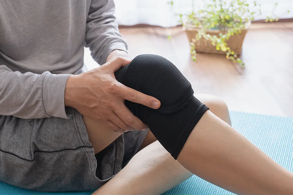 膝を抱える男性